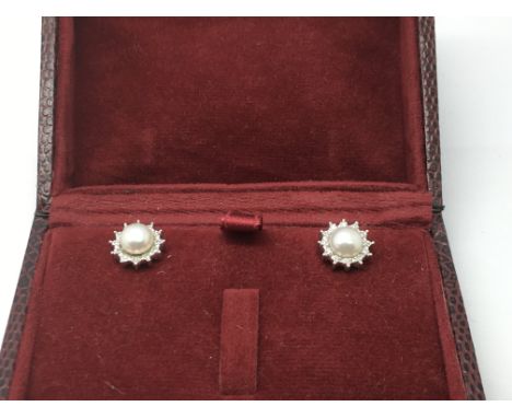 A pair of 9ct white gold cultured pearl and diamond star ear studs, approx 2.7g.