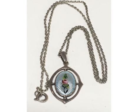 A silver and enamel pendant by Charles Horner on a silver chain, stamps marks on reverse as pictured.