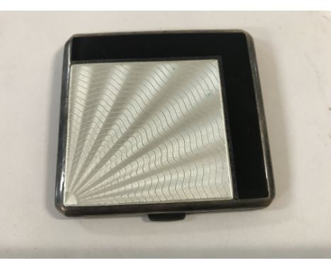 A silver and enamel cigarette case .