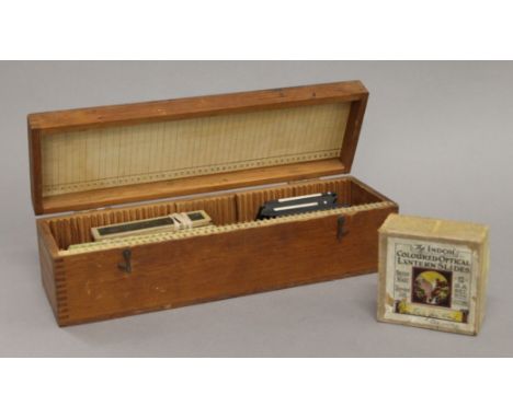 A quantity of various magic lantern slides, including coloured examples, housed in a storage box.