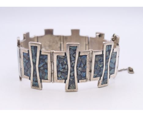 A silver and turquoise bracelet.  18.5 cm long. 