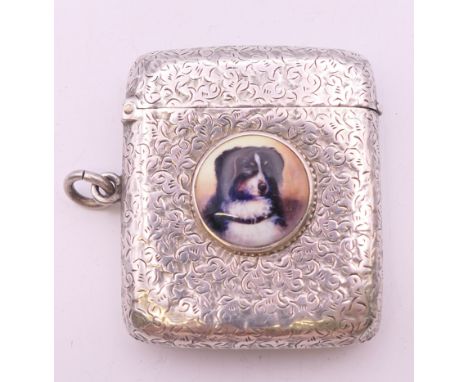 A Victorian silver vesta with leaf chased pattern and dog portrait roundel, Birmingham 1894. 4 cm wide. 34.2 grammes total we