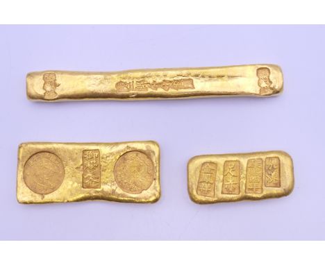 Three Chinese gold coloured bar scroll weights.  The largest 12 cm long.