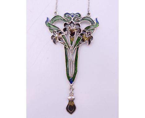 An Art Nouveau style silver pendant on chain.  The pendant 7.5 cm high.