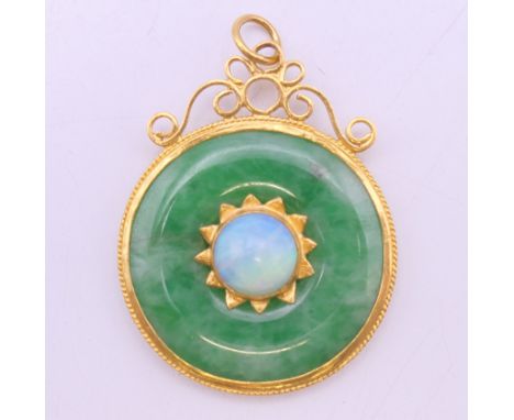 A Chinese unmarked high carat gold mounted jade and opal pendant. 3.75 cm diameter. 8.3 grammes total weight.