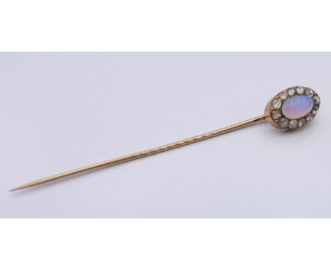 A stick pin set with a opal, the box with Genuine Hasaldo Mine Stone inscription.