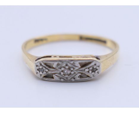 An 18 ct gold, platinum and diamond ring. Ring size M/N. 2.1 grammes total weight.