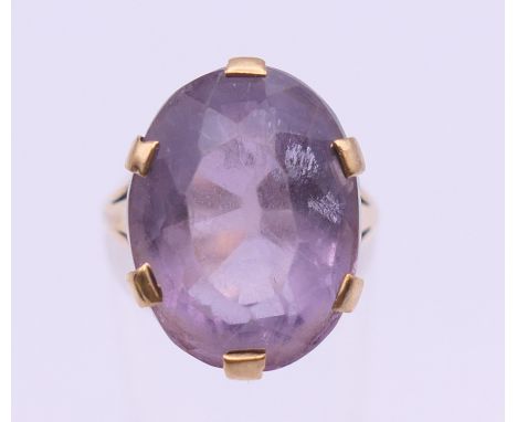 A 9 ct gold amethyst set ring. Ring size L/M. 7.6 grammes total weight.