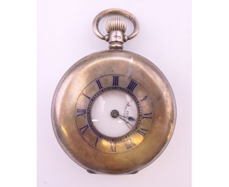 A silver half hunter pocket watch by Dennison. 5 cm diameter.