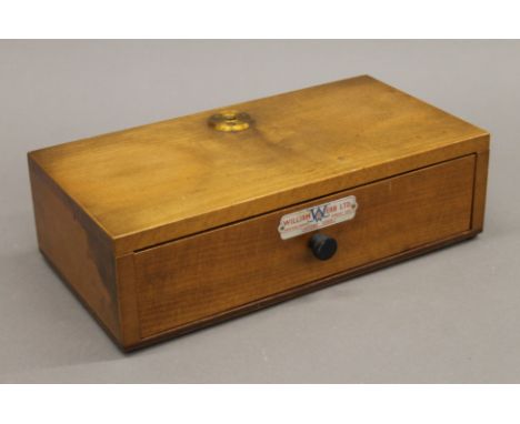 A box of balance scales with weights. 