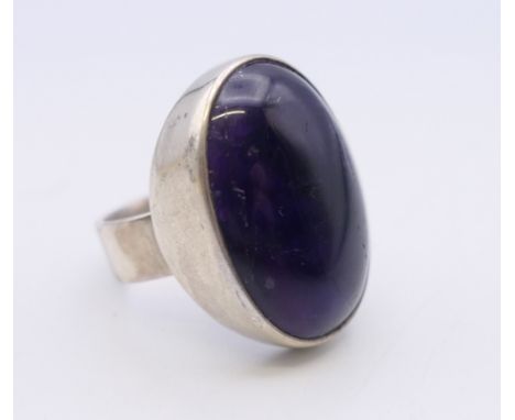 A silver and amethyst ring. Ring size L/M. 11.4 grammes total weight.
