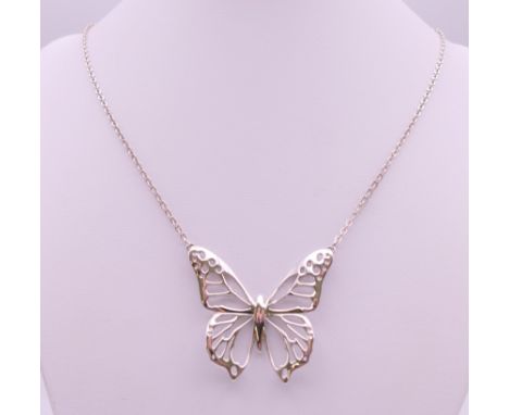 A silver butterfly pendant on a silver chain by Fiorelli. The pendant 4.5 cm wide.