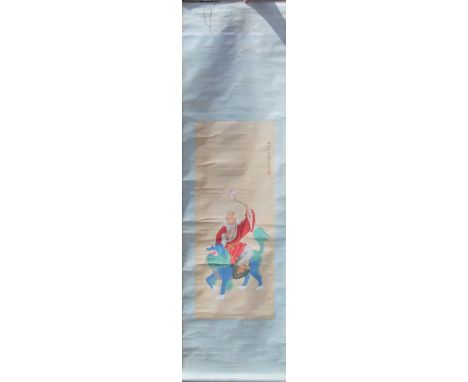 A late 19th/early 20th century Chinese scroll painting of a figure on a dog-of-fo. 55 x 200 cm.