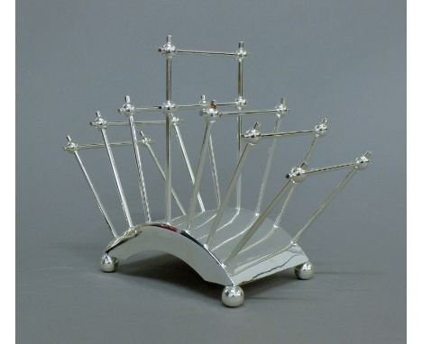 A Christopher Dresser style silver plated toast rack. 17.5 cm high.