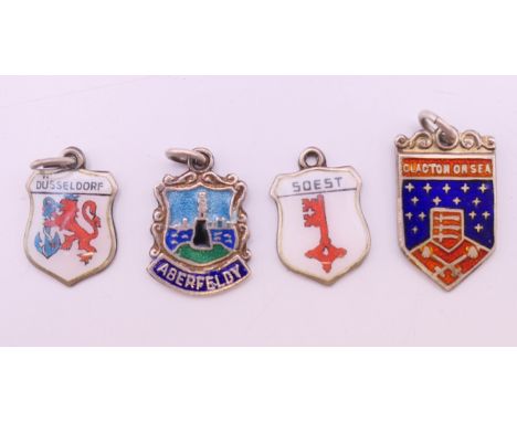 Four silver enamel charms. The largest 2 cm high.