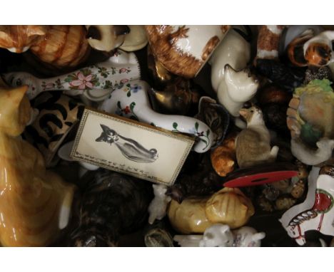 A box of various ceramic models of cats.