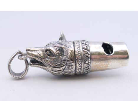 A silver fox mask form whistle. 4 cm long.