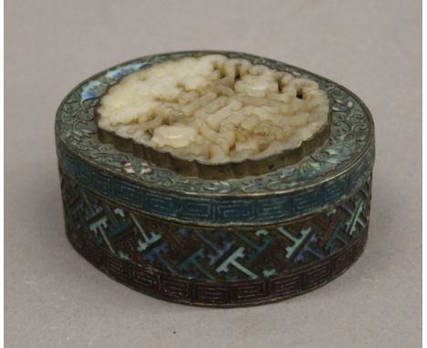 A late 19th/early 20th century Chinese enamel decorated box set with a jade carving. 8 cm long.