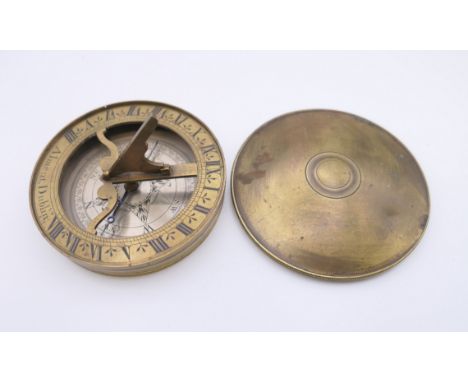 A brass cased pocket sundial compass marked Alment, Dublin. 7.25 cm diameter.