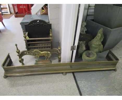 A brass and cast iron fire basket, along with an early 20th century silver plated on brass fire fender, and a brass horse man