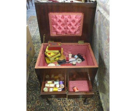 A mid 20th century mahogany work table with contents to include vintage tobacco tins and cotton reels, together with a Victor