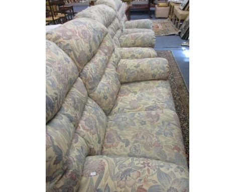 A late 20th century G-Plan two seater sofa with two matching armchairs, in an overstuffed, floral upholstery 