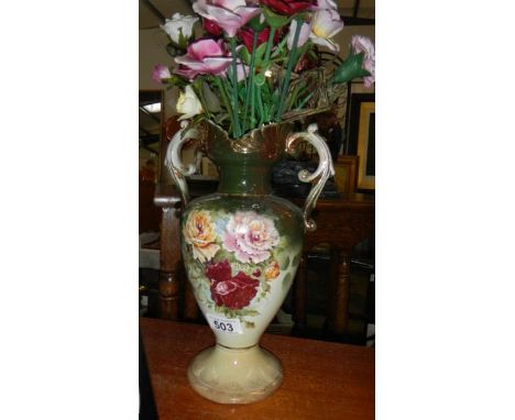 A Staffordshire vase containing ceramic roses
