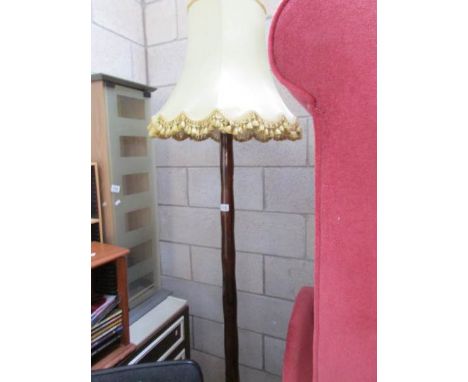 A standard lamp with shade