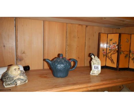 A Chinese Buddha, another Chinese figure, a Chinese teapot, table screen and scroll