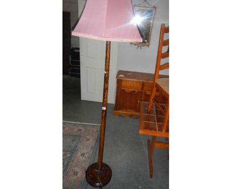 A standard lamp with shade
