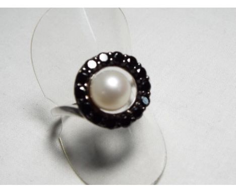 A lady's silver ring set with black diamonds and cultured pearls, size R - Est £20 - £30