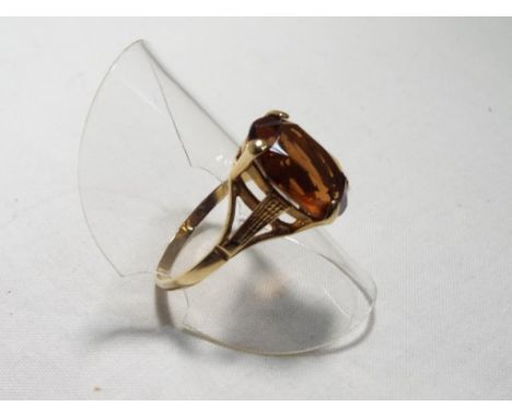 A lady's 9 carat yellow gold dress ring set with a large brown stone, size R, approx. 2.7 gm - Est £25 - £35