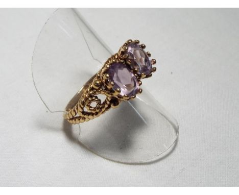 A lady's 9 carat rose gold fancy two stone amethyst dress ring, size R, approx. 4.6 gm - Est £50 - £60