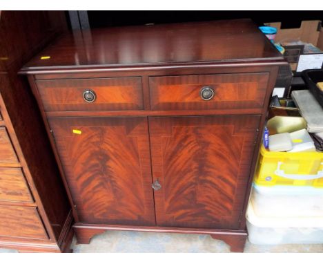 A modern cabinet with twin drawers on bracket feet