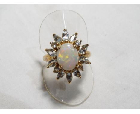 A lady's 9 carat gold opal ring surrounded by cz stones by QVC size T and a half, approximate weight 5.09 grams. Estimate £40