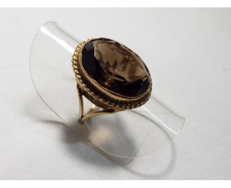 A lady's 9 carat yellow gold smokey quartz dress ring, size K, approx. 4.6 gm - Est £35 - £45