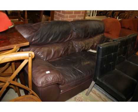 A LARGE BLACK LEATHER THREE SEATER SOFA