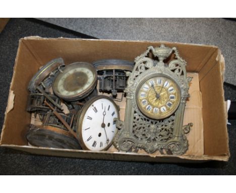 A BOX OF CLOCK MOVEMENTS TOGETHER WITH A VICTORIAN BRASS FRAMED CLOCK  