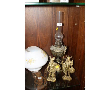 A FIGURATIVE BRASS OIL LAMP TOGETHER WITH TWO BRASS WARRIOR FIGURE