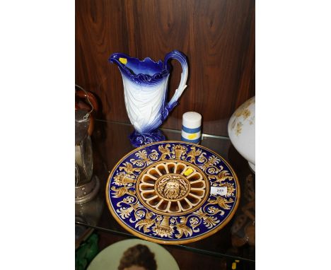 A LATE 19TH CENTURY MAJOLICA BOGEN SCHUTZE CHARGER WITH GREEN MAN CENTRAL DETAIL, TOGETHER WITH CORNISH WARE SUGAR SHAKER AND