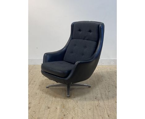 A 1970's Danish style easy chair, the faux black leather seat raised on a four point chrome revolving base, H100cm, W82cm, D9