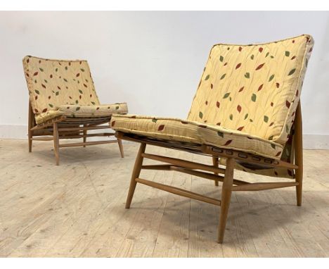 Ercol, a pair of model 427 mid 20th century beech framed lounge chairs, with squab cushions, raised on turned supports