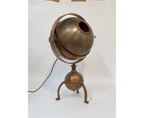 An unusual copper lamp, the shade of spherical form swivelling and revolving over three bowed supports, H65cm