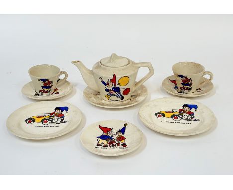 A 1960's child's Noddy themed part tea service comprising three saucers, two teacups, three plates and a teapot ( l - 15cm h-