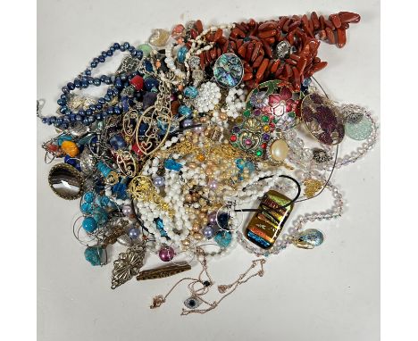 A white metal mounted open work circular pendant necklace mounted with turquoise boulder style beads, a dyed blue cultured pe