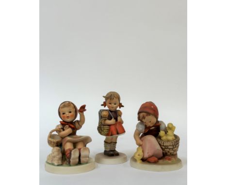 A group of three Hummel figures comprising "Chick Girl", "Farewell" and a girl wearing a backpack holding a basket. (h- 14.5c