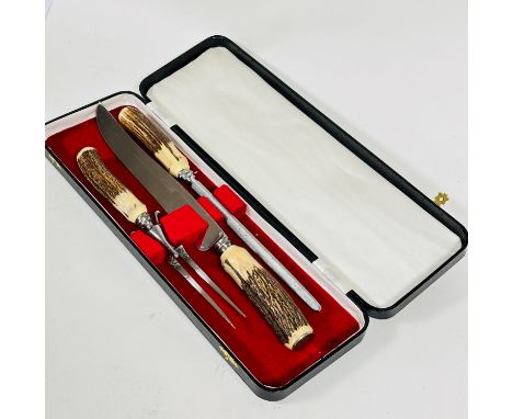 A case containing 3 piece horn handled carving set including knife, steel and fork