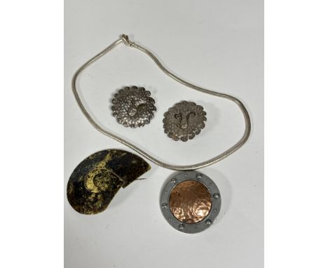 A Liberty pewter shield shaped brooch with centre hammered copper effect panel, signed verso, (d:5cm) an anodised brass lacqu