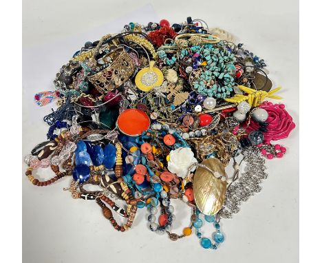 A large collection of costume jewellery including yellow metal stiff pierced circular bangle, a lion's head yellow metal bang