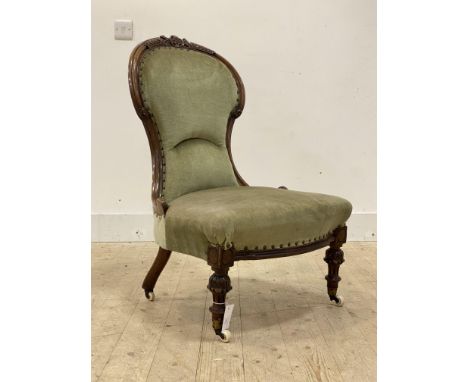 A Victorian mahogany framed spoon back chair, the carved crest rail and show frame enclosing seat and back upholstered in gre